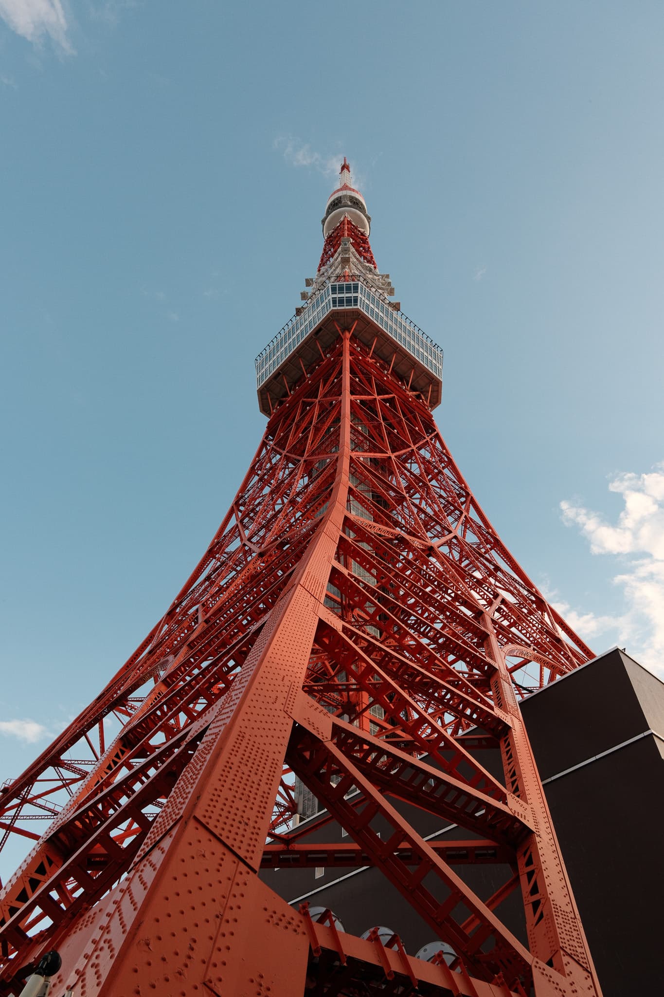 Looking up at the red steel structure of Tokyo Tower