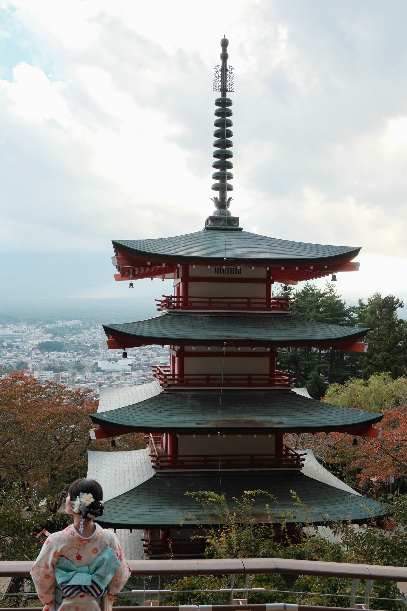 A red pagoda overlooking a city