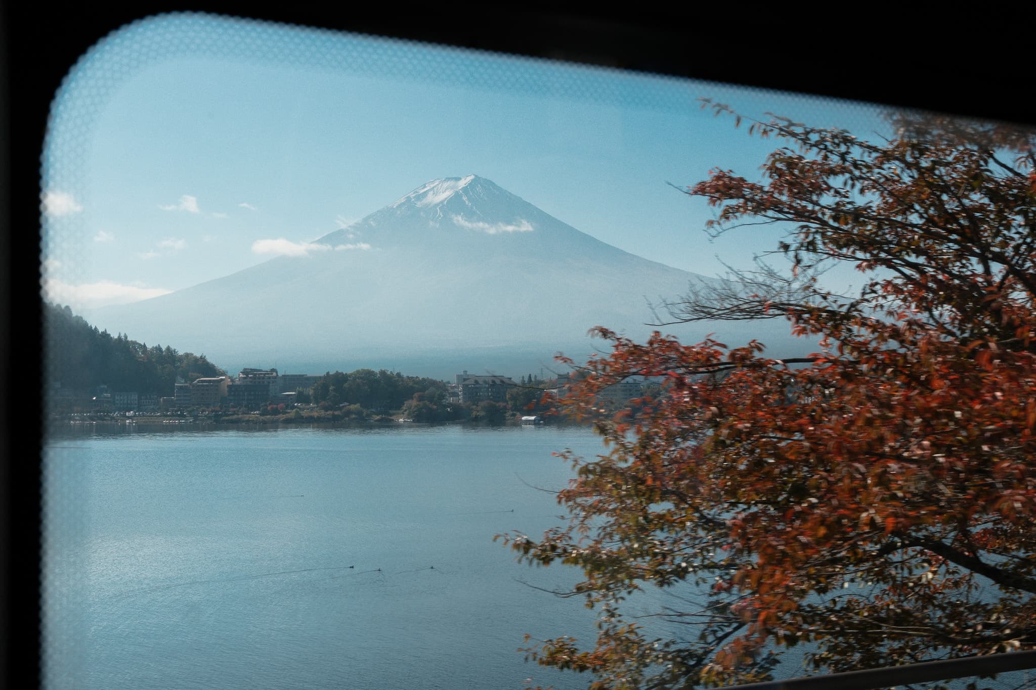 Mount Fuji and a lake seen through a window