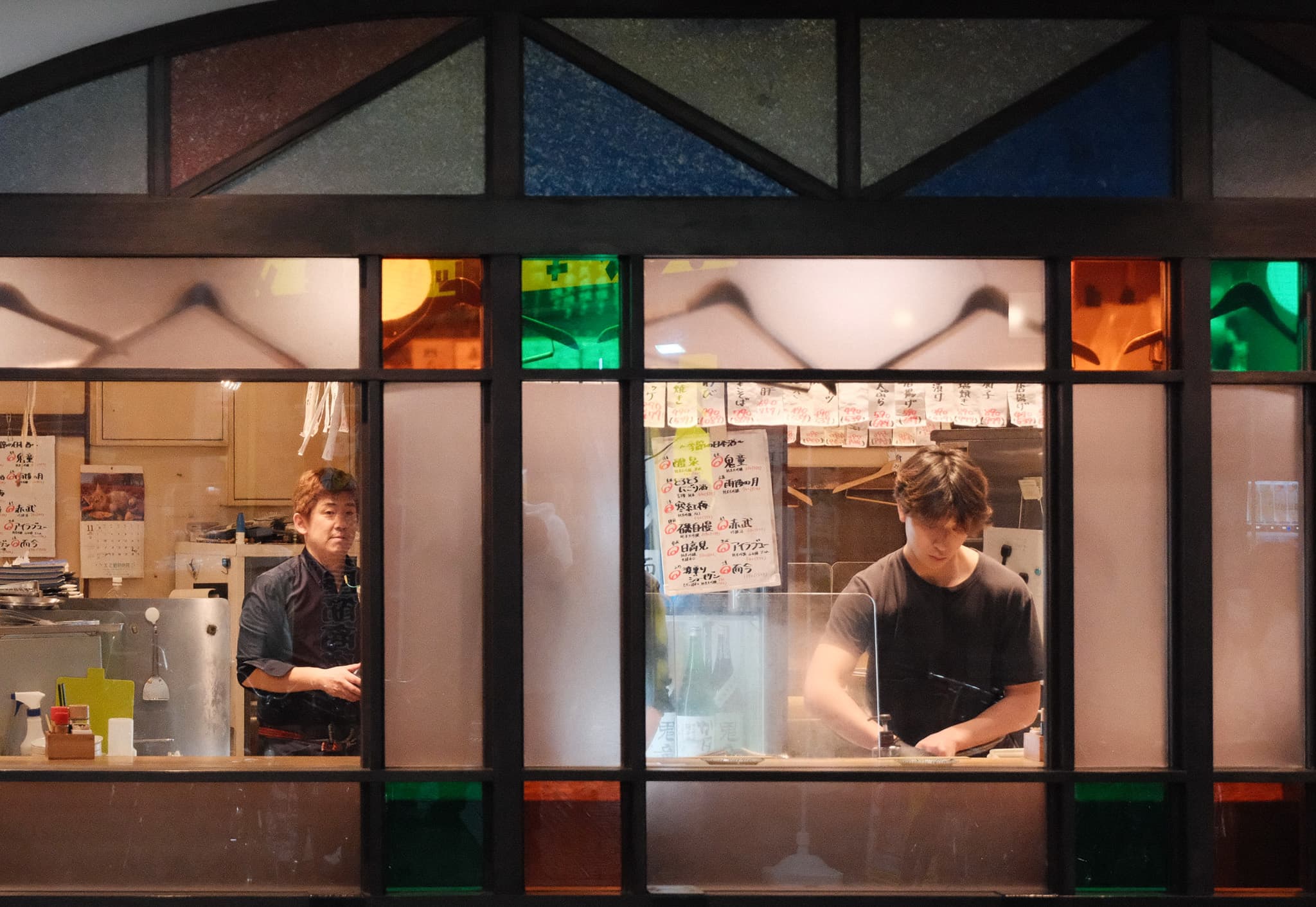 A person working inside a warmly lit restaurant