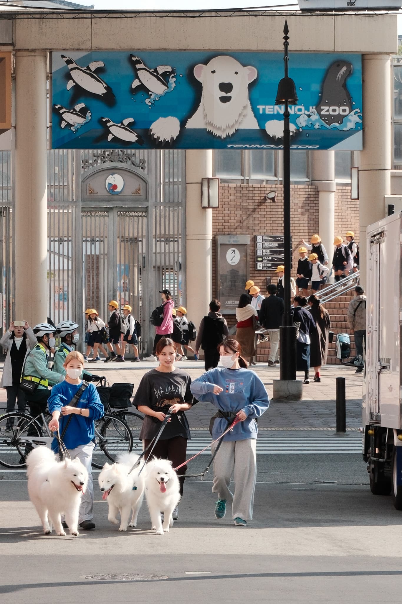 Pedestrians moving through a busy covered shopping entrance